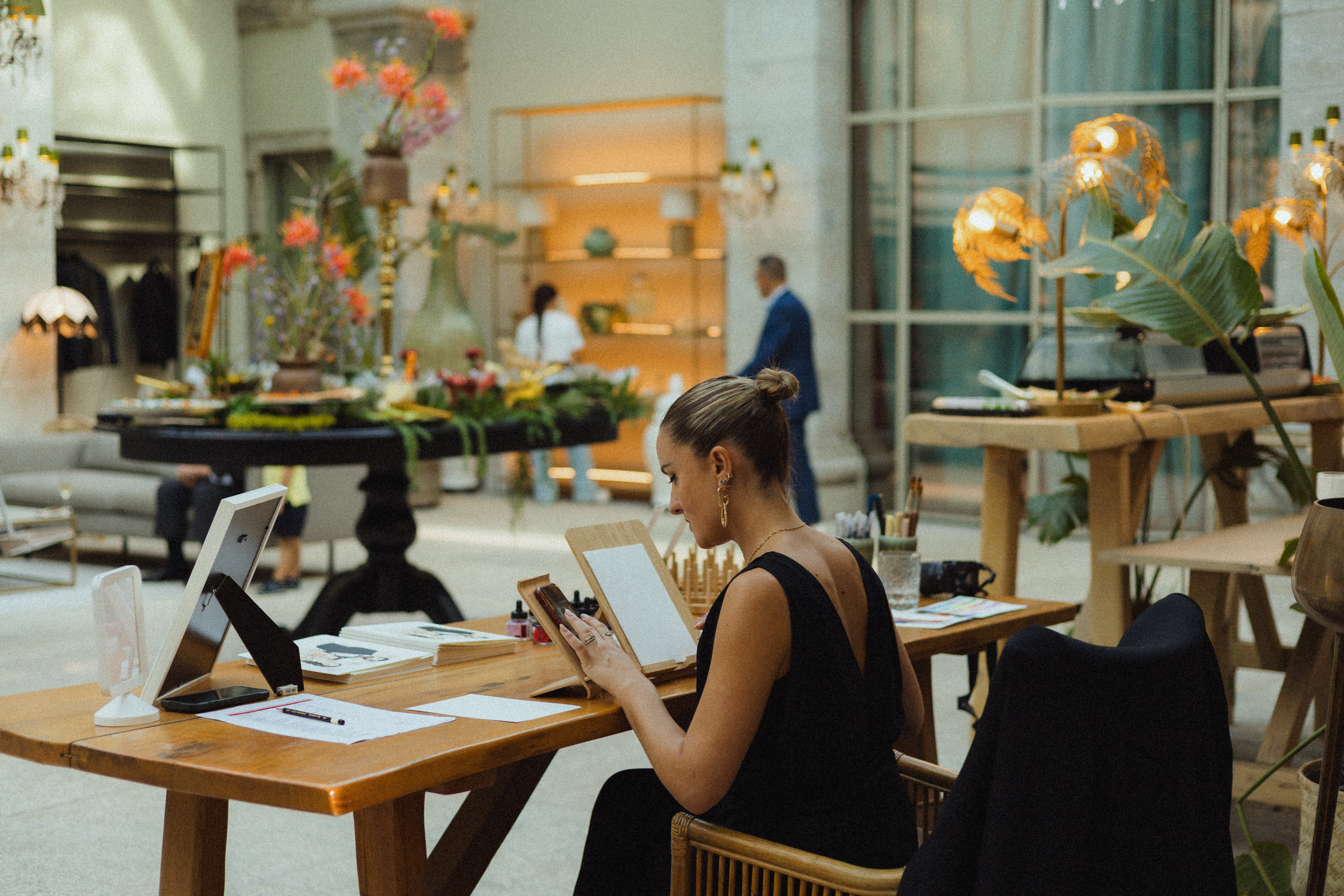 A delicate and sophisticated fashion illustration of a woman in a flowing dress.